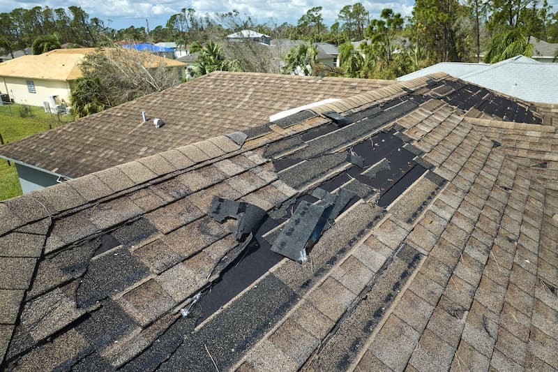 Wind damaged shingles on a roof in Central Ohio